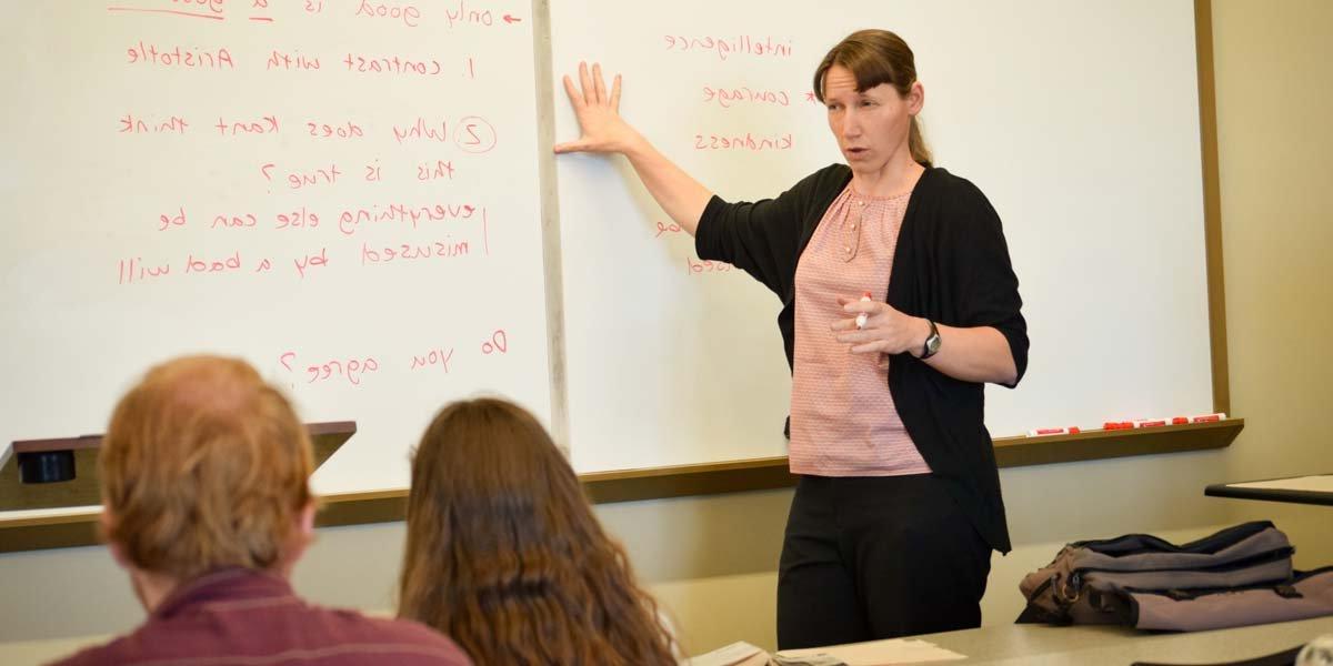 Dr. Jamie Spiering teaches philosophy at the whiteboard